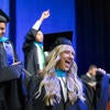Graduates celebrating on stage